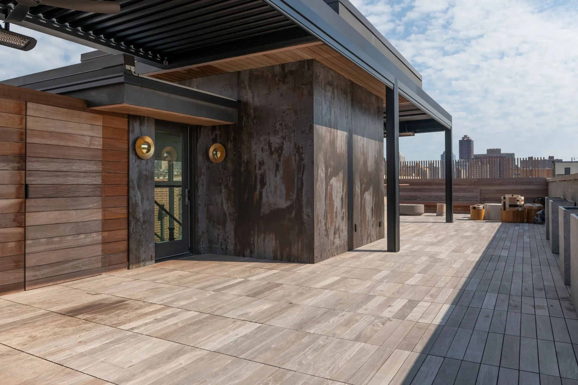 Covered outdoor terrace with a clad fireplace